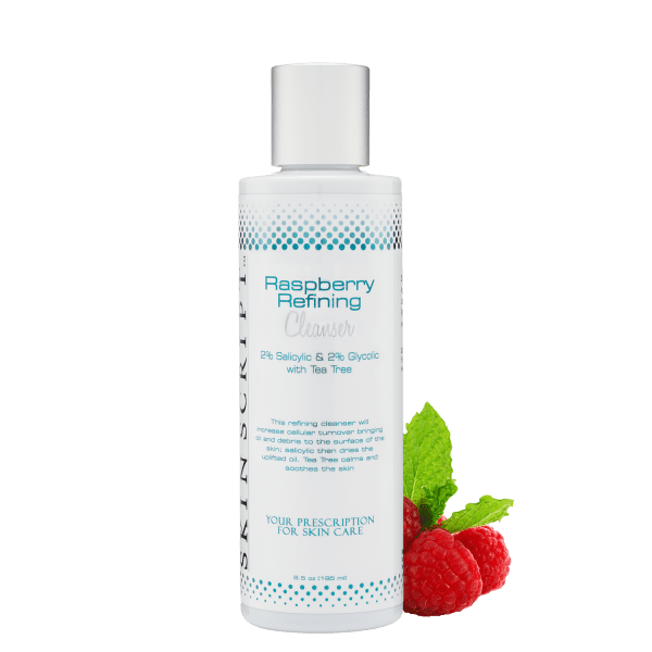 A bottle of raspberry refining lotion next to raspberries.