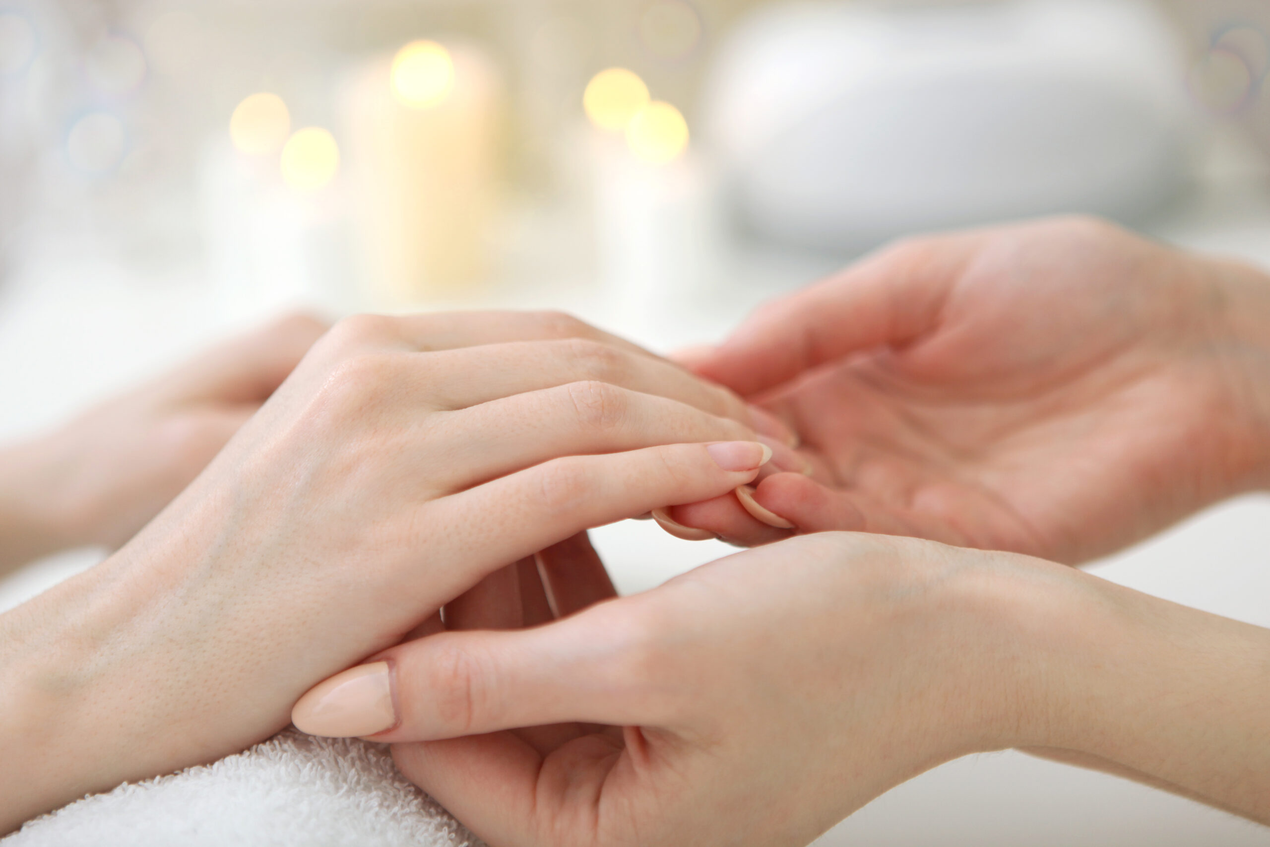 Closeup shot of a woman in a nail salon getting a manicure by a cosmetologist with a nail file. Woman gets a manicure of nails. Beautician puts nails on the client. High quality photo